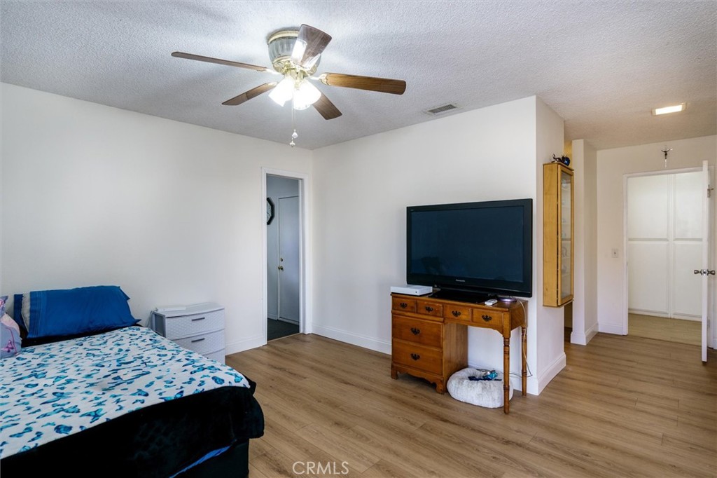 27062 Terrytown Road Menifee, CA 92586 - Photo 22 of 36 a bedroom with a bed and a flat screen tv
