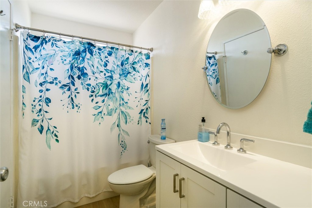 27062 Terrytown Road Menifee, CA 92586 - Photo 26 of 36 a bathroom with a sink mirror and toilet