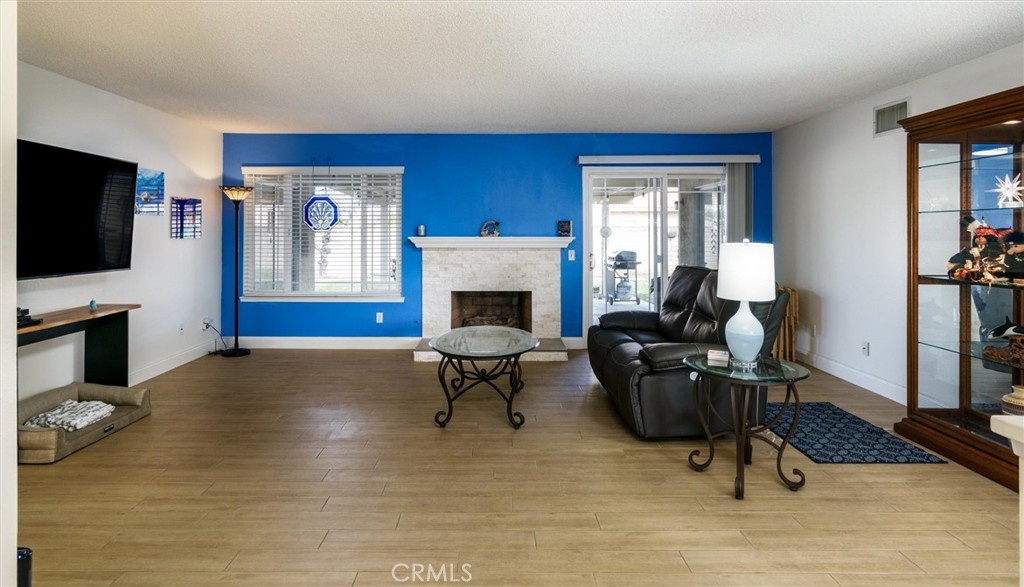 27062 Terrytown Road Menifee, CA 92586 - Photo 9 of 36 a living room with furniture a fireplace and a flat screen tv