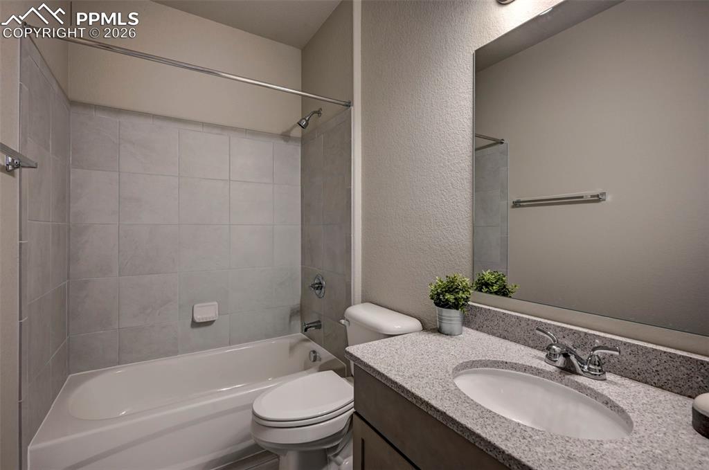 5167 Truscott Road Colorado Springs, CO 80925 - Photo 14 of 20 a bathroom with a granite countertop sink toilet and shower