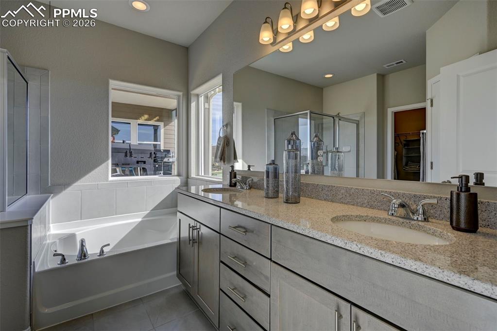 5167 Truscott Road Colorado Springs, CO 80925 - Photo 19 of 20 a bathroom with a sink double vanity granite and a mirror