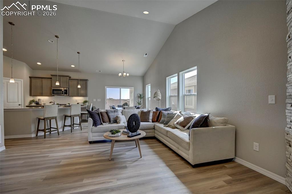 5167 Truscott Road Colorado Springs, CO 80925 - Photo 5 of 20 a living room with furniture and a wooden floor