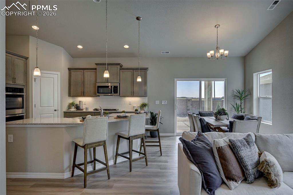 5167 Truscott Road Colorado Springs, CO 80925 - Photo 6 of 20 a large kitchen with a table and chairs