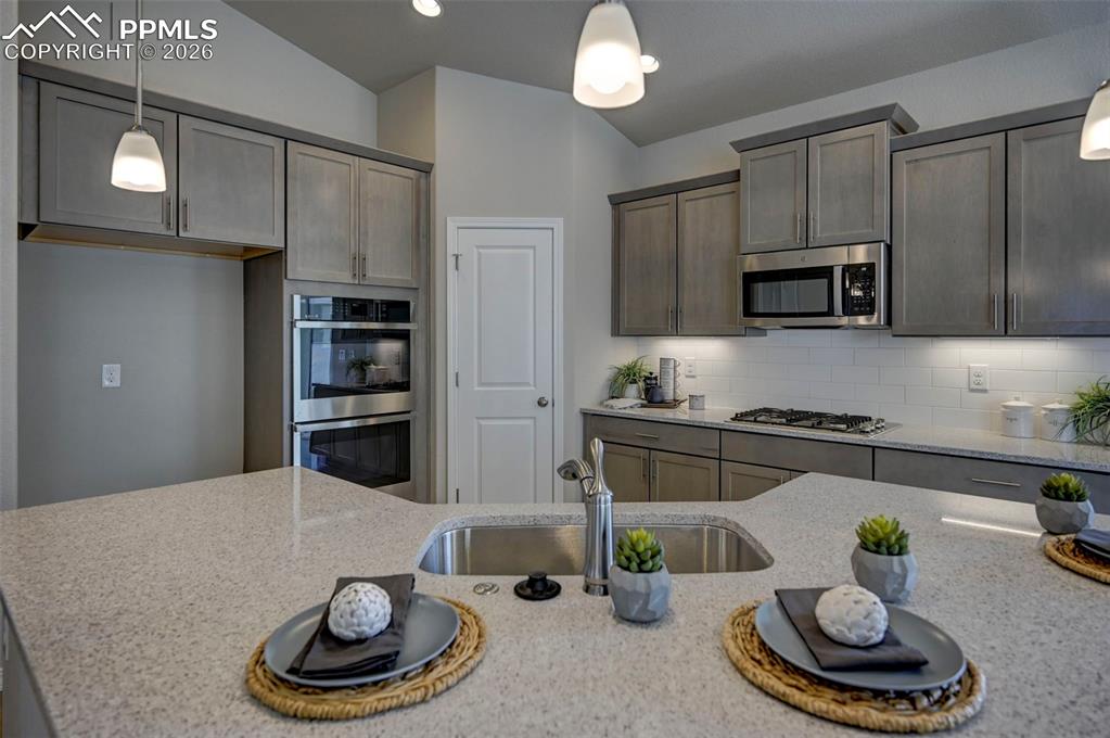 5167 Truscott Road Colorado Springs, CO 80925 - Photo 7 of 20 a kitchen with a refrigerator a stove and cabinets
