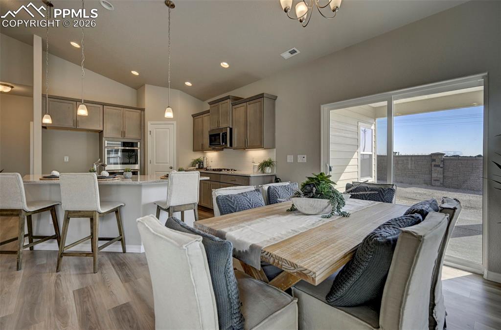 5167 Truscott Road Colorado Springs, CO 80925 - Photo 9 of 20 a view of a dining room with furniture window and wooden floor