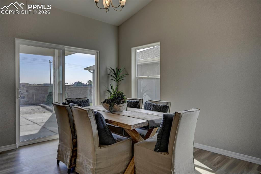 5167 Truscott Road Colorado Springs, CO 80925 - Photo 10 of 20 a view of a dining room with furniture window and wooden floor