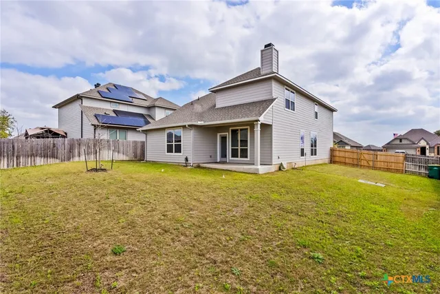 a front view of house with yard and swimming pool
