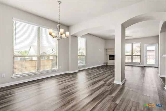 a view of a room with wooden floor and windows