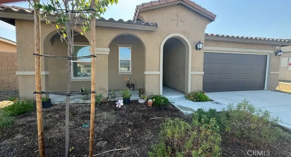 a front view of a house with garden