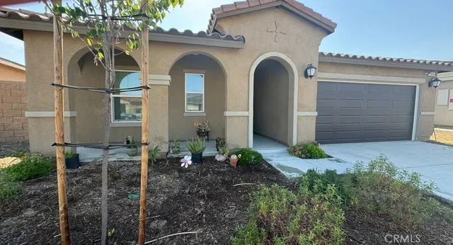 a front view of a house with garden