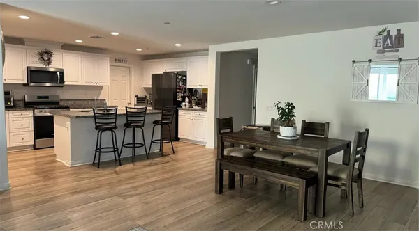 a view of a dining room with furniture and wooden floor