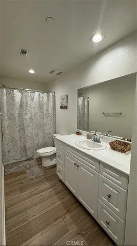 a bathroom with a double vanity sink toilet and a shower