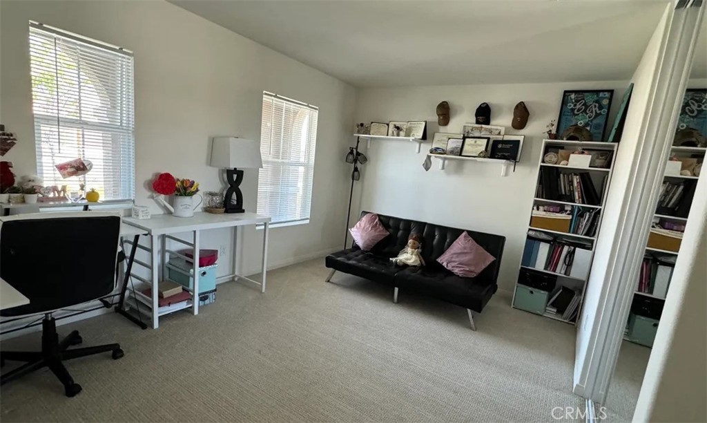 29045 Silver Stirrup Way Winchester, CA 92596 - Photo 4 of 11 a living room with furniture and a book shelf