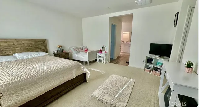 a bedroom with a bed and a flat screen tv