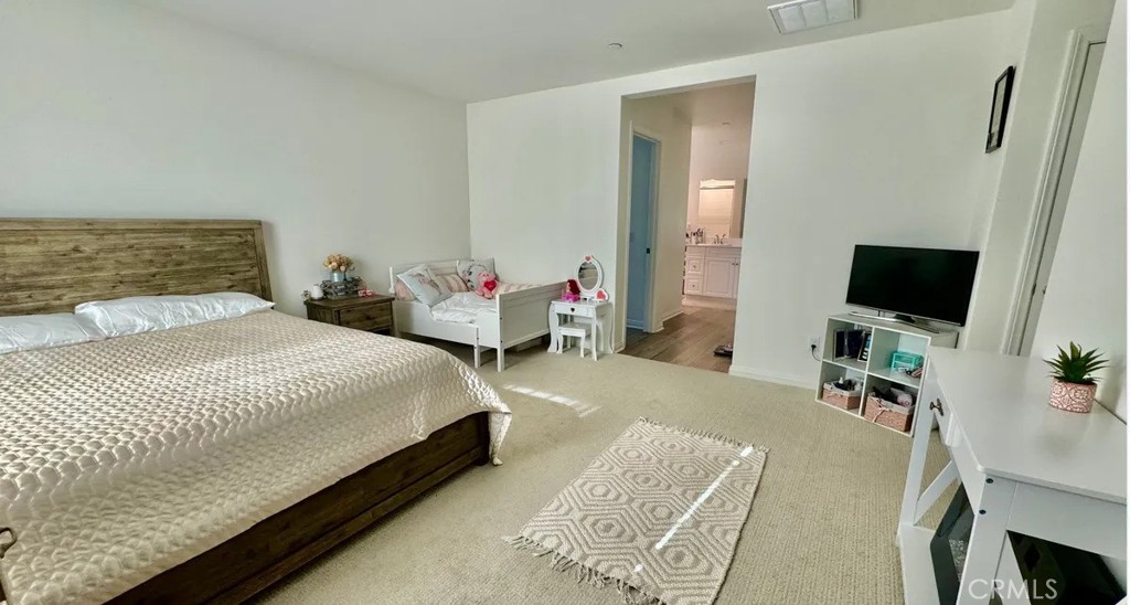 29045 Silver Stirrup Way Winchester, CA 92596 - Photo 7 of 11 a bedroom with a bed and a flat screen tv
