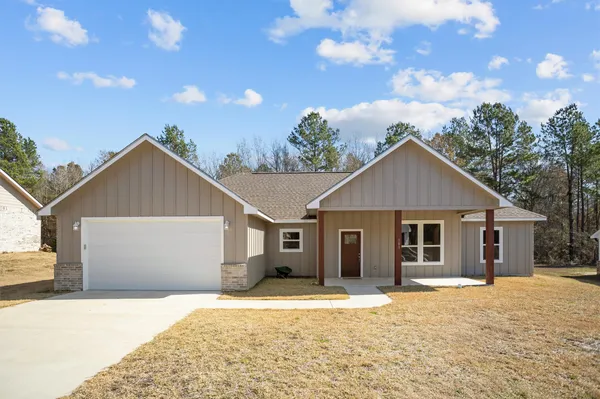 a view of a house with a yard and garage