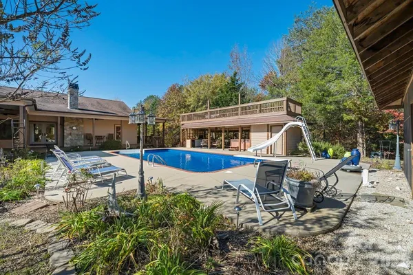 a view of a house with backyard sitting area and garden