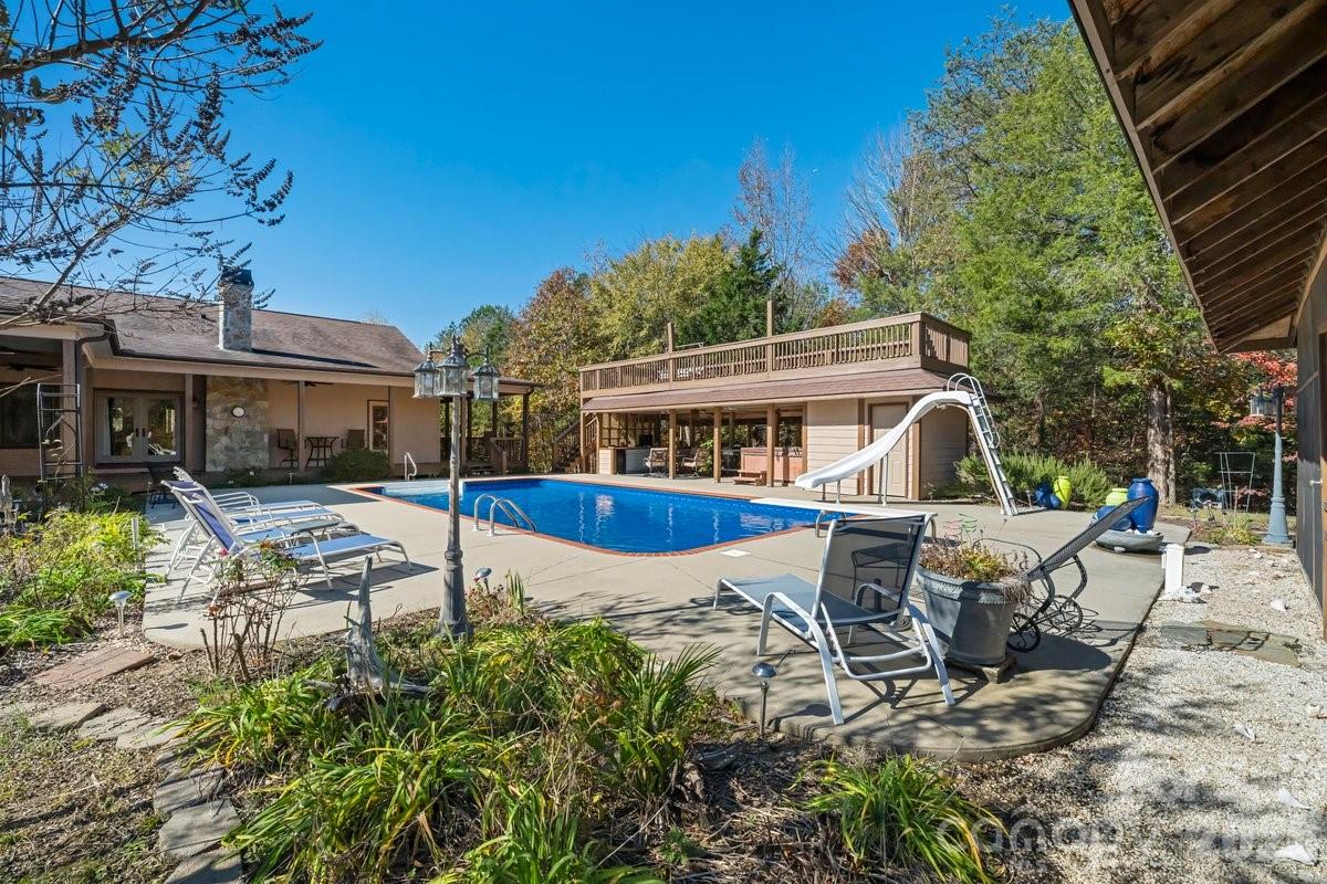 a view of a house with backyard sitting area and garden