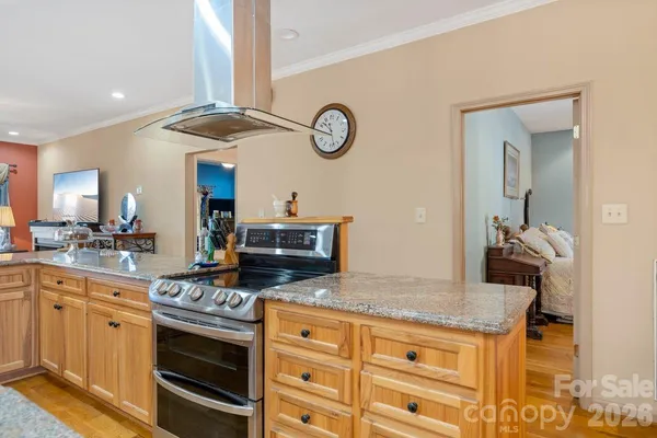 a kitchen with stainless steel appliances granite countertop a stove and a sink