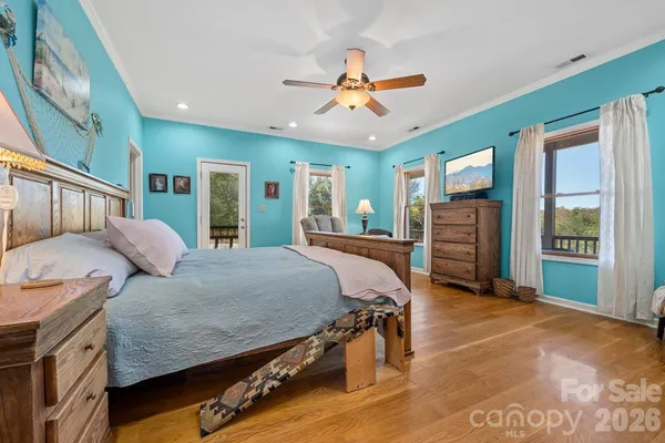 a bed room with a bed window and a ceiling fan