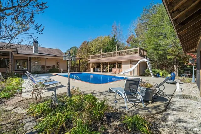 a view of a house with backyard sitting area and garden