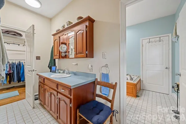 a bedroom with furniture and a chandelier fan