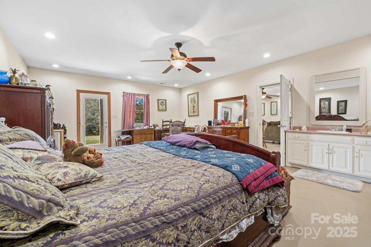 492 State Rd S-11-586 Gaffney, SC 29340 - Photo 33 of 45 a bedroom with a large bed and a chandelier