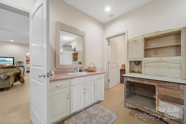 a spacious bathroom with a double vanity sink and a mirror