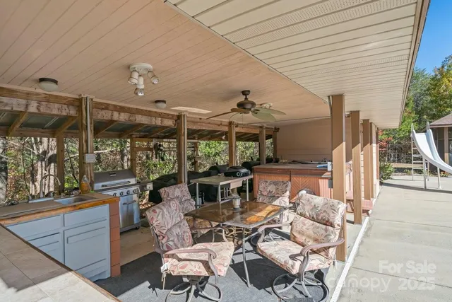 a view of a patio with table and chairs potted plants with wooden floor