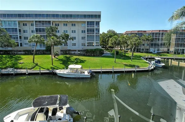 a view of swimming pool with outdoor seating and lake view