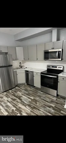 a view of kitchen with stove top oven