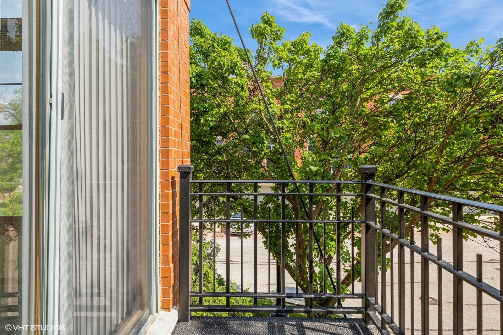162 Dawson Drive Elgin, IL 60120 - Photo 12 of 15 a view of a balcony with floor to ceiling windows and wooden fence