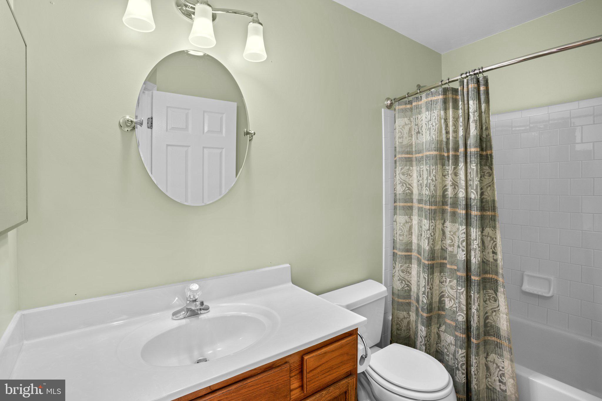 6342 Arbor Way Elkridge, MD 21075 - Photo 19 of 38 a bathroom with a sink a toilet and shower