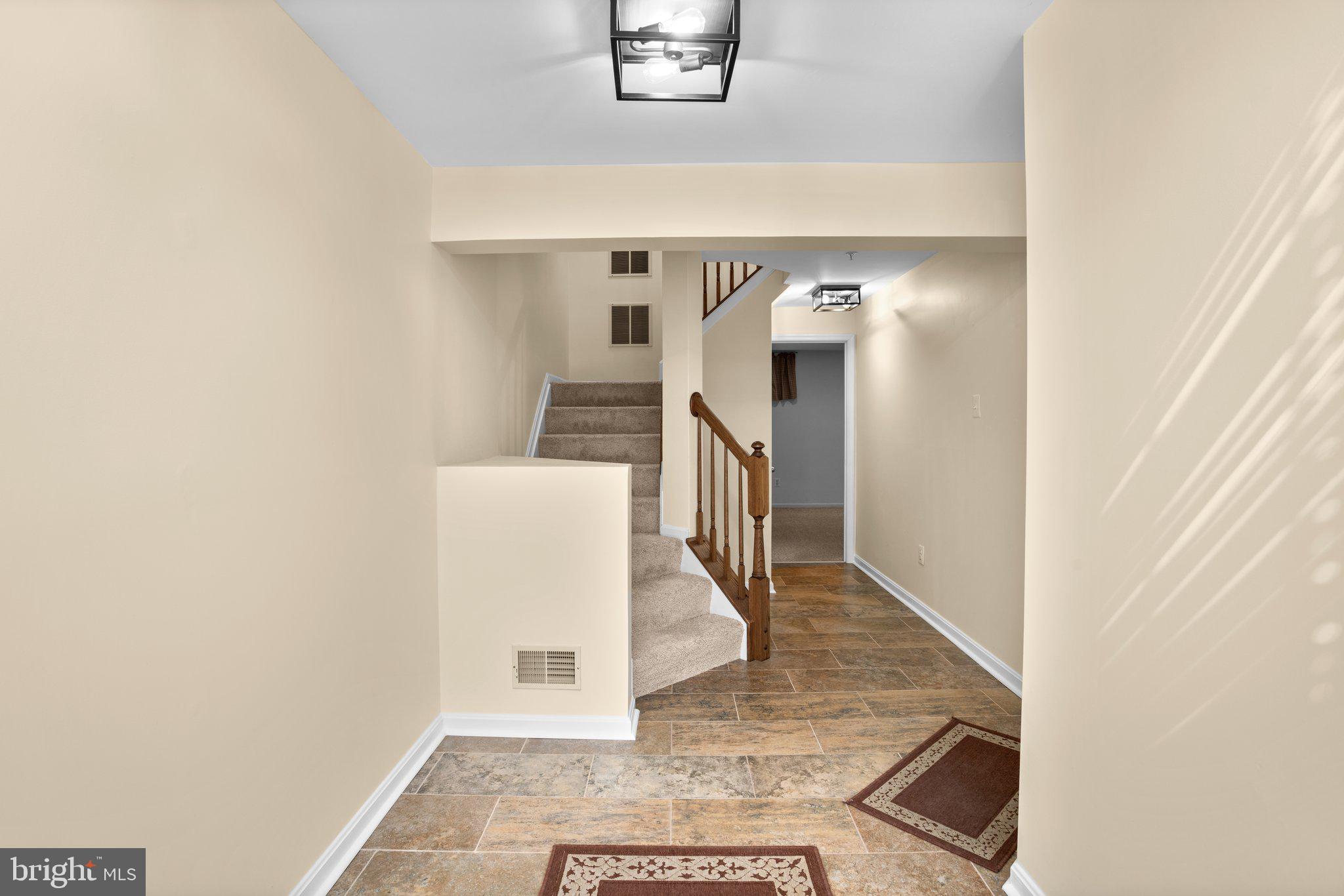 6342 Arbor Way Elkridge, MD 21075 - Photo 20 of 38 a view of a hallway with wooden floor and staircase