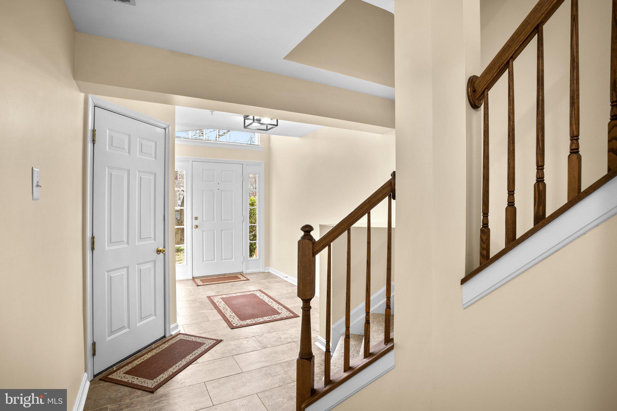 6342 Arbor Way Elkridge, MD 21075 - Photo 21 of 38 a view of a hallway with wooden floor and staircase