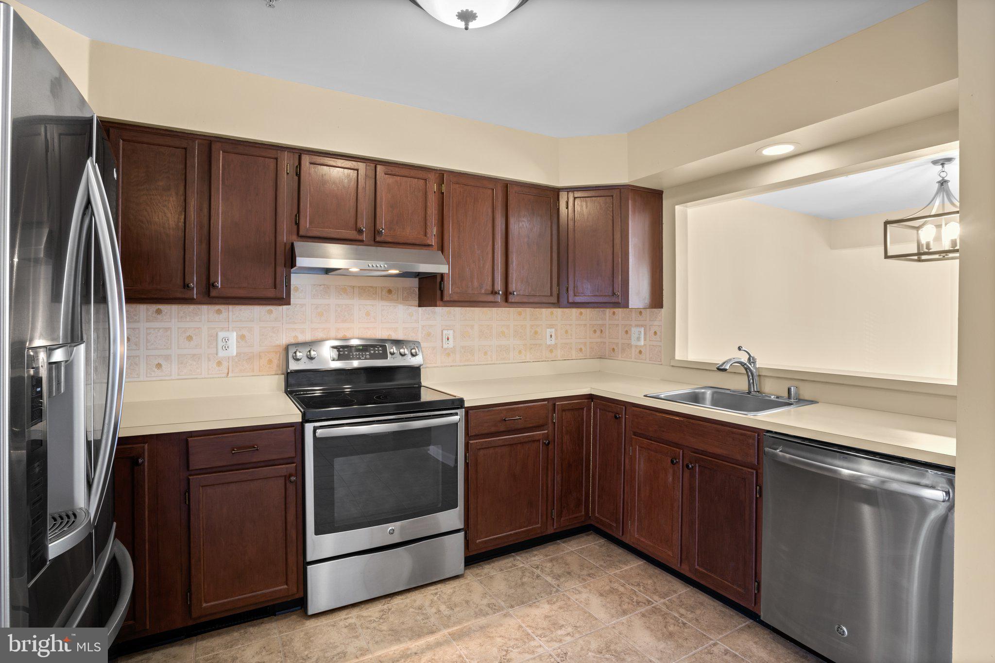 6342 Arbor Way Elkridge, MD 21075 - Photo 7 of 38 a kitchen with a sink stove and cabinets