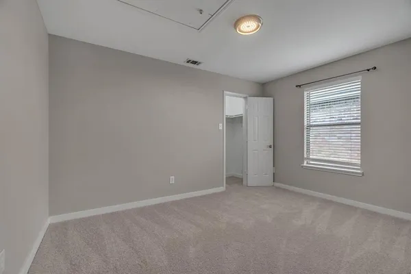 an empty room with a empty space and windows