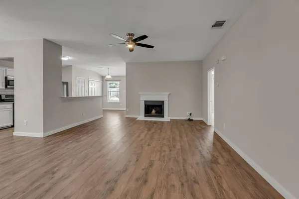 a view of a kitchen with a sink and wooden floor