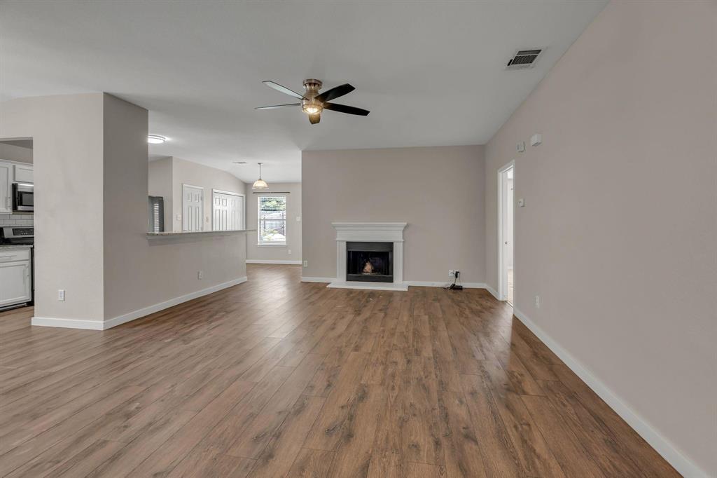 3920 Cane River Road Fort Worth, TX 76244 - Photo 17 of 22 a view of an empty room with a fireplace and a window