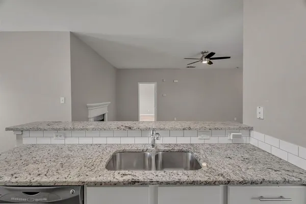 a kitchen with granite countertop a sink and a granite counter tops