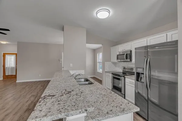 a kitchen with a refrigerator and a sink