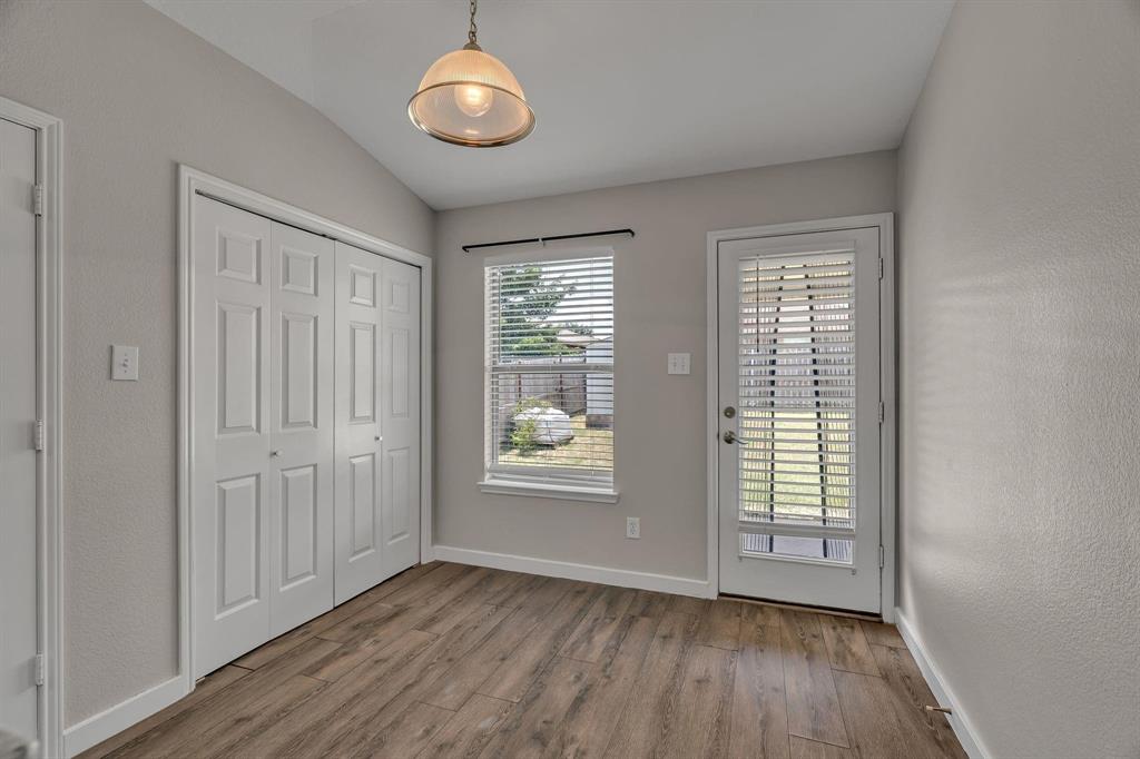 3920 Cane River Road Fort Worth, TX 76244 - Photo 4 of 22 an empty room with wooden floor and windows