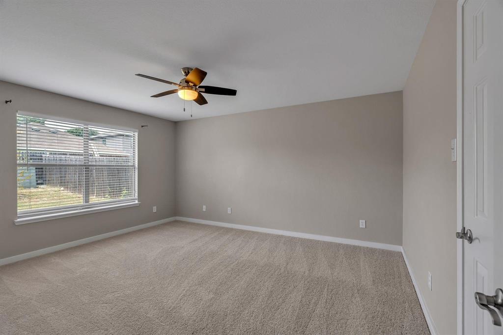 3920 Cane River Road Fort Worth, TX 76244 - Photo 6 of 22 an empty room with chandelier fan and windows