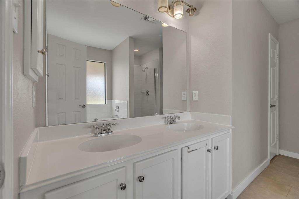 3920 Cane River Road Fort Worth, TX 76244 - Photo 8 of 22 a bathroom with a sink double vanity and a mirror