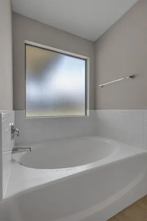 a bathroom with a bathtub and a shower