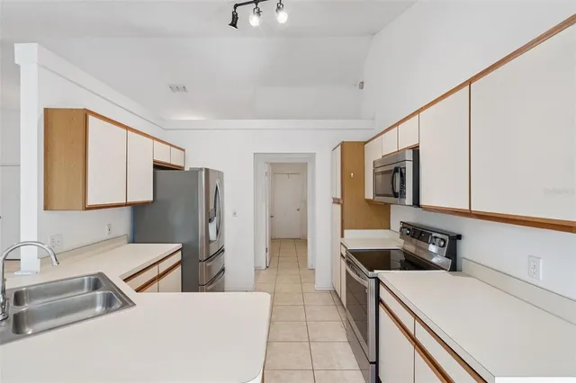 a kitchen with a refrigerator and a sink