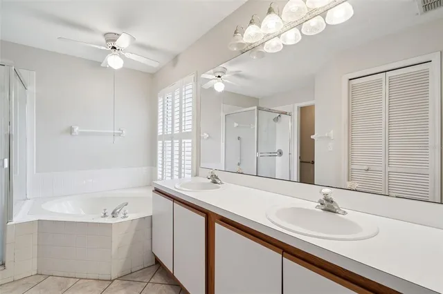 an empty room with wooden floor and ceiling fan