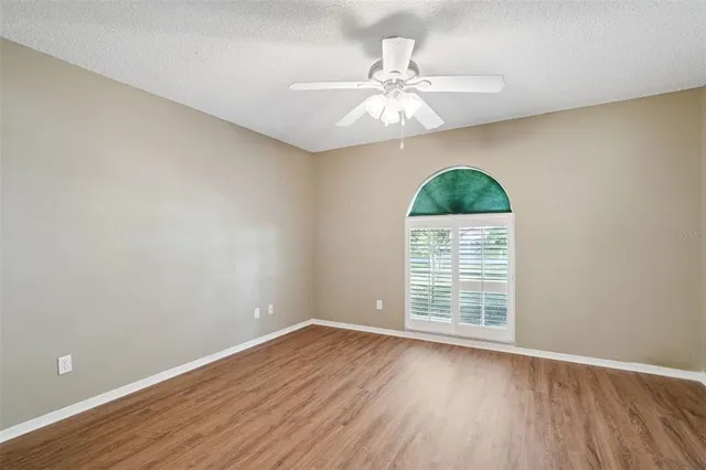 a view of room with window and a ceiling fan