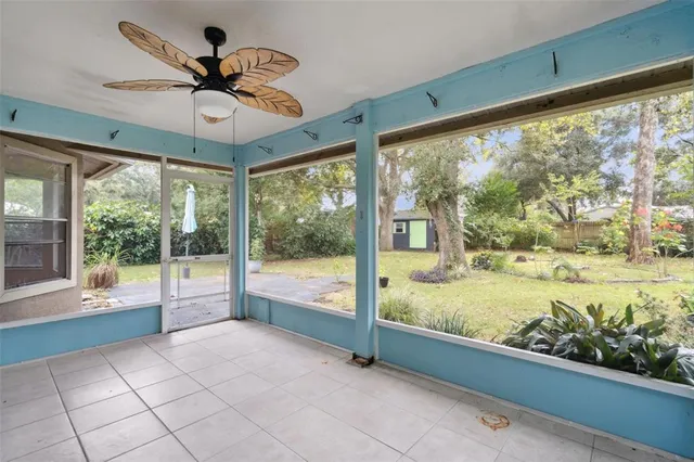 a view of a house with backyard and trees