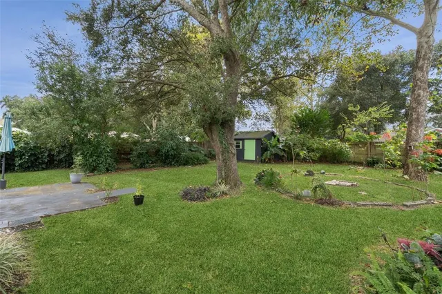 a front view of a house with a yard table and chairs